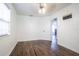 Bright bedroom with wood floors, ceiling fan, and a doorway to other parts of the home at 1807 23Rd N Ave, St Petersburg, FL 33713