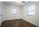 Cozy bedroom featuring wood floors, natural light from two windows, and a ceiling fan at 1807 23Rd N Ave, St Petersburg, FL 33713