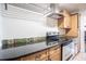 Kitchen counter with stainless steel appliances, wooden cabinets, and colorful backsplash at 1807 23Rd N Ave, St Petersburg, FL 33713