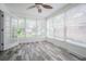 Bright sunroom features wood tile flooring, large windows, and serene views at 1807 23Rd N Ave, St Petersburg, FL 33713