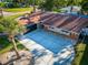 Aerial view of a single story house with a spacious driveway, lush landscaping, and a well-maintained red-tiled roof at 2096 Church Creek Pt, Largo, FL 33774