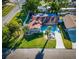 Bird's-eye view of the home featuring lush landscaping, a fenced backyard, and a spacious driveway at 2096 Church Creek Pt, Largo, FL 33774