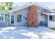 Brick chimney enhances the backyard, alongside a cozy patio perfect for outdoor lounging at 2096 Church Creek Pt, Largo, FL 33774