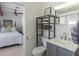 Stylish bathroom featuring a gray vanity with shelving, adjacent to a serene bedroom view at 2096 Church Creek Pt, Largo, FL 33774