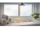 Window detail with towels, rocks and plant adding warmth to the bathroom space at 2096 Church Creek Pt, Largo, FL 33774