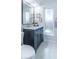 Bathroom vanity featuring gray cabinets, marble countertops, and a framed mirror at 2096 Church Creek Pt, Largo, FL 33774