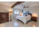 Bright bedroom featuring a beam, ceiling fan, white bedding, and neutral-toned walls at 2096 Church Creek Pt, Largo, FL 33774