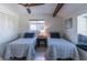 Bright bedroom features two beds, ceiling fan, and a charming window nook, creating a cozy and inviting space at 2096 Church Creek Pt, Largo, FL 33774