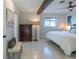 Bright bedroom featuring a beam, light walls, and matching nightstands at 2096 Church Creek Pt, Largo, FL 33774