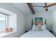 Bedroom features a bed with white linens, a ceiling fan, and a cozy window nook, creating a serene space at 2096 Church Creek Pt, Largo, FL 33774