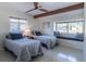Bright bedroom featuring twin beds and a cushioned window bench for lounging at 2096 Church Creek Pt, Largo, FL 33774