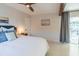 Bright bedroom featuring a beam, white bedding, and connecting kitchen at 2096 Church Creek Pt, Largo, FL 33774