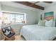 Bedroom features a bed with white linens, a ceiling fan, and a cozy window nook, creating a serene space at 2096 Church Creek Pt, Largo, FL 33774