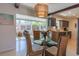 Bright dining area with a glass table, wicker chairs, and view to a living area at 2096 Church Creek Pt, Largo, FL 33774
