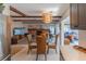 Open-concept dining area with wicker chairs, hardwood floors, and brick fireplace offers a cozy and stylish space at 2096 Church Creek Pt, Largo, FL 33774