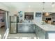 Modern kitchen with gray cabinetry, stainless appliances, and an open layout with views of the bedroom at 2096 Church Creek Pt, Largo, FL 33774