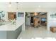 Modern kitchen with stainless appliances, a breakfast bar, and an open view to the dining area at 2096 Church Creek Pt, Largo, FL 33774