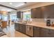 Well-lit kitchen with quartz countertops, stainless steel appliances, and gray cabinets at 2096 Church Creek Pt, Largo, FL 33774