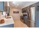 Modern kitchen featuring stainless steel appliances and gray cabinets at 2096 Church Creek Pt, Largo, FL 33774