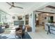 Bright living area showcasing open layout, stylish furniture, and seamless transition to a sunroom with abundant natural light at 2096 Church Creek Pt, Largo, FL 33774