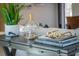 Living room detail showcasing stylish décor, including books, glass display, and golden glasses on a wooden table at 2096 Church Creek Pt, Largo, FL 33774