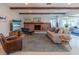 Cozy living room with a brick fireplace, stylish furniture, and natural light, offering a relaxing atmosphere at 2096 Church Creek Pt, Largo, FL 33774