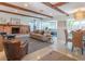 Spacious living room featuring exposed beams, a brick fireplace, and comfortable seating arrangements at 2096 Church Creek Pt, Largo, FL 33774