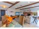 Open concept living, dining, and kitchen area with wood beams and plenty of light at 2096 Church Creek Pt, Largo, FL 33774