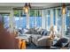Bright sun room features ample windows, a comfortable sectional sofa, and stylish decor for relaxation at 2096 Church Creek Pt, Largo, FL 33774