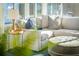Cozy sunroom features a comfortable sectional sofa, ottoman, and ample natural light from large windows at 2096 Church Creek Pt, Largo, FL 33774