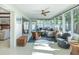 Inviting sunroom with a comfortable seating area, ceiling fan, and lots of windows that bring in natural light at 2096 Church Creek Pt, Largo, FL 33774