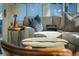 Close-up of a cozy sunroom featuring a comfortable gray sectional sofa, stylish pillows, and natural light at 2096 Church Creek Pt, Largo, FL 33774