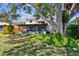 Exterior backyard with screened in porch and lush landscaping at 2199 Springrain Dr, Clearwater, FL 33763
