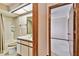 Bathroom featuring a shower and tub, along with a view to another room at 2199 Springrain Dr, Clearwater, FL 33763