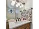 Stylish bathroom vanity with decorative mirror, stone accents, and modern lighting fixtures at 2199 Springrain Dr, Clearwater, FL 33763