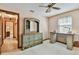 Bedroom with view of the hallway has carpet and blue-green painted dresser and desk at 2199 Springrain Dr, Clearwater, FL 33763