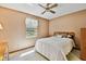 Cozy bedroom featuring a ceiling fan, bright window, and comfortable furniture at 2199 Springrain Dr, Clearwater, FL 33763