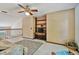 Bright bonus room with ceiling fan, built in shelving, and plush carpet at 2199 Springrain Dr, Clearwater, FL 33763