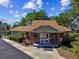 Charming single-story clubhouse building featuring brick accents and a well-maintained landscape under a partly cloudy blue sky at 2199 Springrain Dr, Clearwater, FL 33763