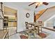 Casual dining area with a staircase and a glimpse into the kitchen at 2199 Springrain Dr, Clearwater, FL 33763