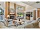 Open living room with large windows overlooking the lake and a decorative brick fireplace at 2199 Springrain Dr, Clearwater, FL 33763