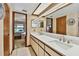 Main bathroom features double sink vanity and view into main bedroom at 2199 Springrain Dr, Clearwater, FL 33763