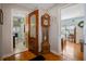 Hallway view with hardwood floors leads to bathroom and bedroom at 225 Garden S Cir, Dunedin, FL 34698