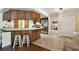 View of the kitchen with wood cabinets, stainless steel appliances, and tile flooring at 2504 Hawk Griffin Rd, Plant City, FL 33565