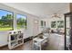 Sunroom with tile floors, large windows, a ceiling fan, and white walls at 2504 Hawk Griffin Rd, Plant City, FL 33565