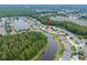 An aerial view of a home, surrounded by lush greenery and water views, offering a private retreat at 25323 Lexington Oaks Blvd, Wesley Chapel, FL 33544