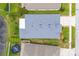 Aerial view of a home with a gray roof, landscaping, and pond at 25323 Lexington Oaks Blvd, Wesley Chapel, FL 33544