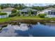 Landscaped backyard featuring banana trees and pond, providing a serene outdoor space and screened lanai at 25323 Lexington Oaks Blvd, Wesley Chapel, FL 33544
