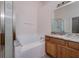 Bathroom showcasing soaking tub, shower, granite countertop and wooden cabinets at 25323 Lexington Oaks Blvd, Wesley Chapel, FL 33544
