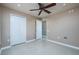 Bedroom with tiled floors, ceiling fan and an open door at 25323 Lexington Oaks Blvd, Wesley Chapel, FL 33544